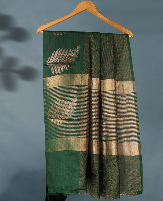 Bottle Green Colour Semi Tussar Silk saree featuring golden zari horizontal lines across the body, adorned with bold Leaf motifs on the border, paired with a matching blouse.
