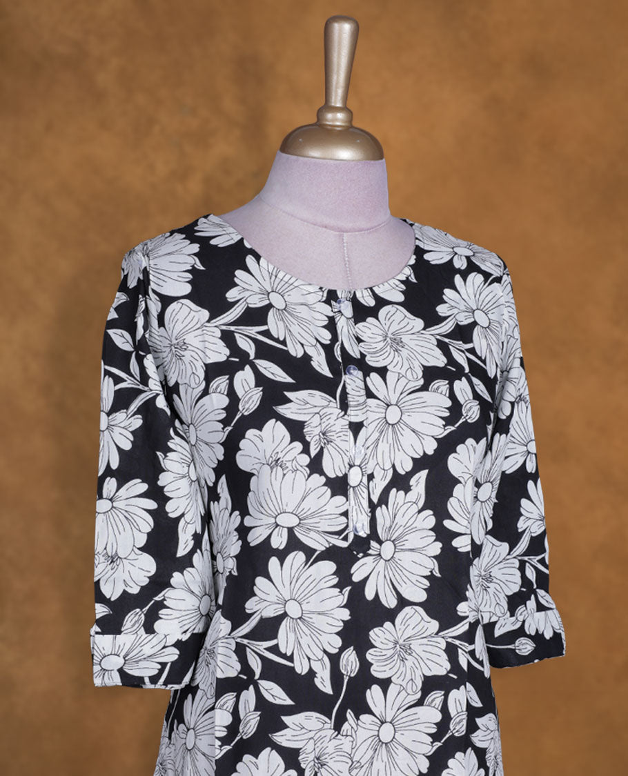 Black and white colour kurti with White floral prints, knee length design, styled with a round neckline and a sleeve .
