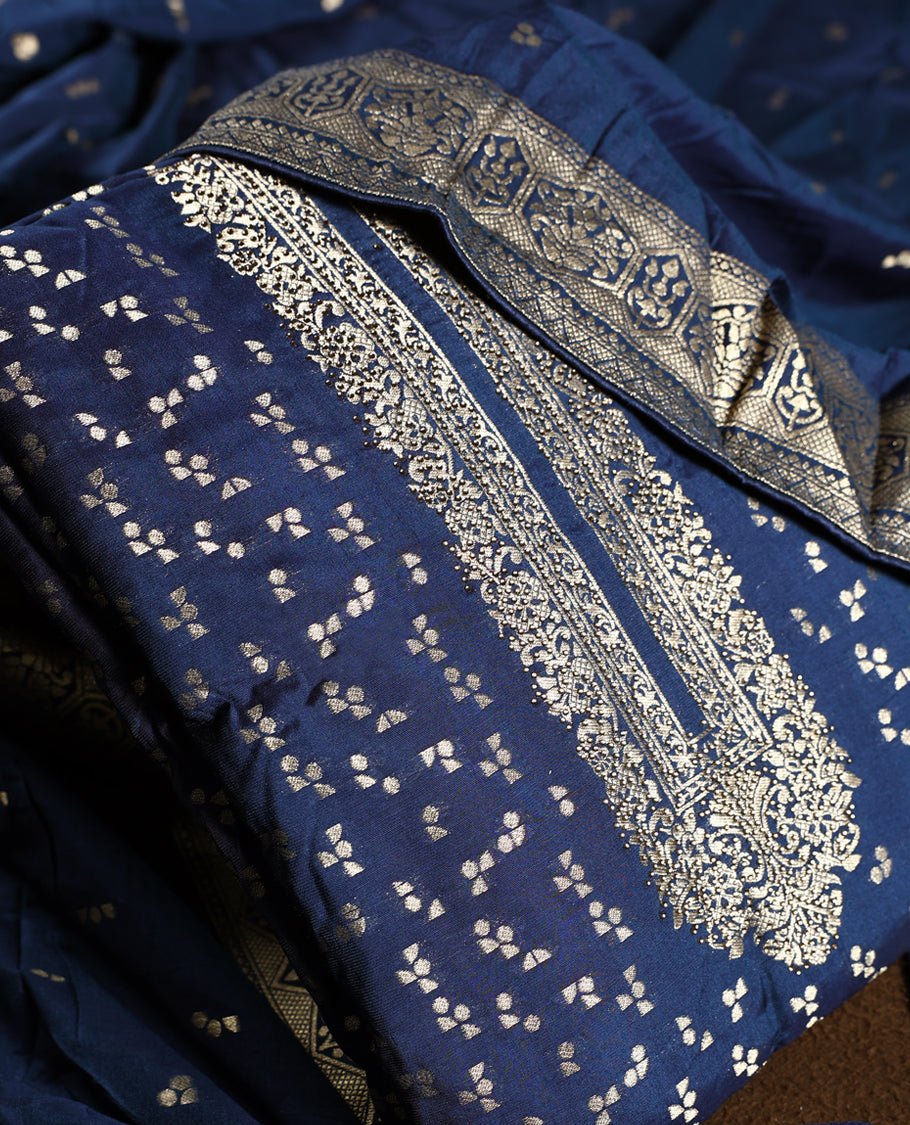 Regal navy blue churidhar material embellished with golden zari floral motifs and an ornate woven border, paired with a plain matching bottom and grand dupatta, perfect for weddings, festive occasions, and royal celebrations.