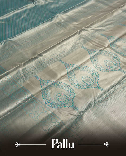 Aqua blue colour and Antique gold Zari Tissue Brocade Saree features intricate line Motifs on body and traditional border & pallu with floral patterns, paired with matching blouse