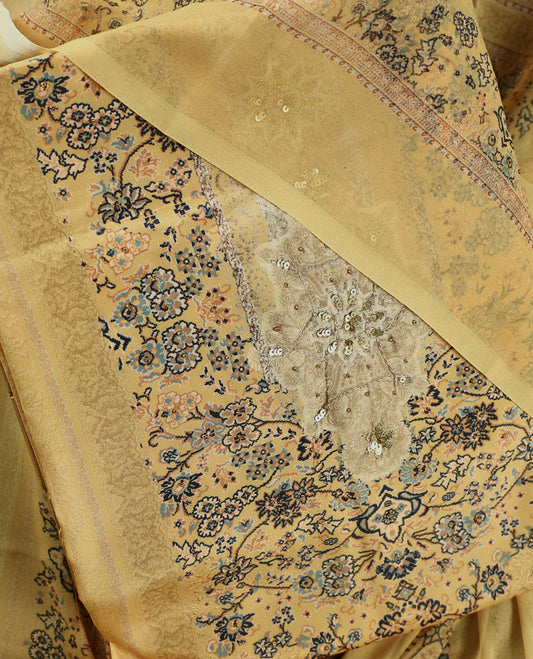 Pastel yellow colour churidhar material with intricate floral prints, sequin embroidery on the top, plain matching bottom, and a coordinated dupatta.