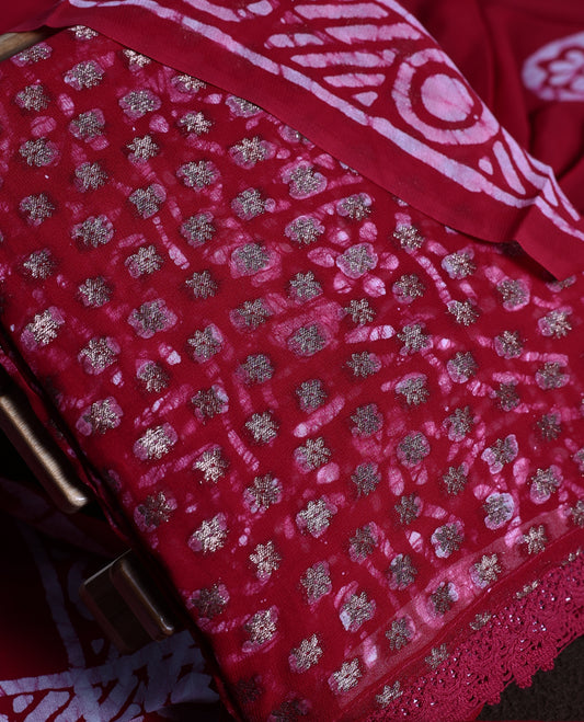 Maroon colour churidhar material adorned with gold and copper toned floral patterns and bold block designs, paired with a plain matching bottom and stylish dupatta, perfect for festive evenings and traditional gatherings.