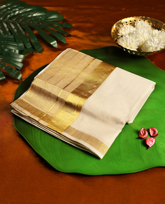 Off white pure handloom cotton double dhoti featuring a grand golden zari kara with rich woven detailing, crafted to reflect traditional splendour, making it perfect for weddings, festivals, and auspicious occasions.