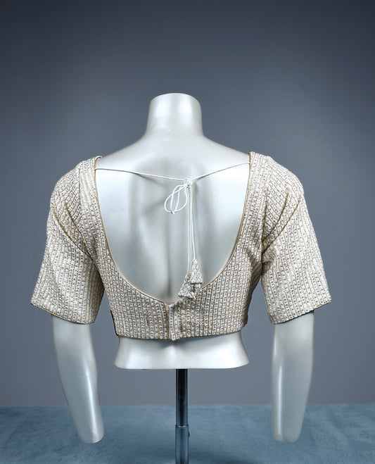 Champagne beige designer padded readymad blouse embellished with vertical sequin lines, featuring a sweetheart neckline and elbow length sleeves.