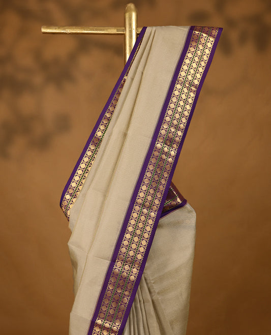 Beige Colour soft silk saree with a plain body, highlighted by a striking contrast Poun design border paired with a plain blouse in a matching contrasting tone