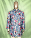Steel blue men's kurta adorned with vibrant pink and orange floral prints, featuring a Mandarin collar, half-button placket, and full sleeves for a bold, contemporary festive look.