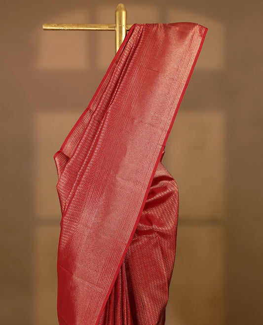 Red Colour Manthrakodi saree featuring a golden zari brocade body, complemented by a self coloured zigzag brocade border and a matching blouse.