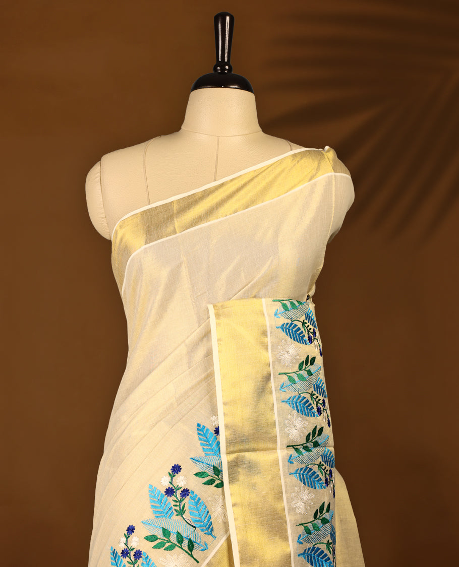 Light Gold colour Tissue Kerala saree featuring Plain body and a beautifully woven Gold Kasavu border with multi  colour Heavy Floral embroidery work, paired with a matching blouse perfect for festive occasions.