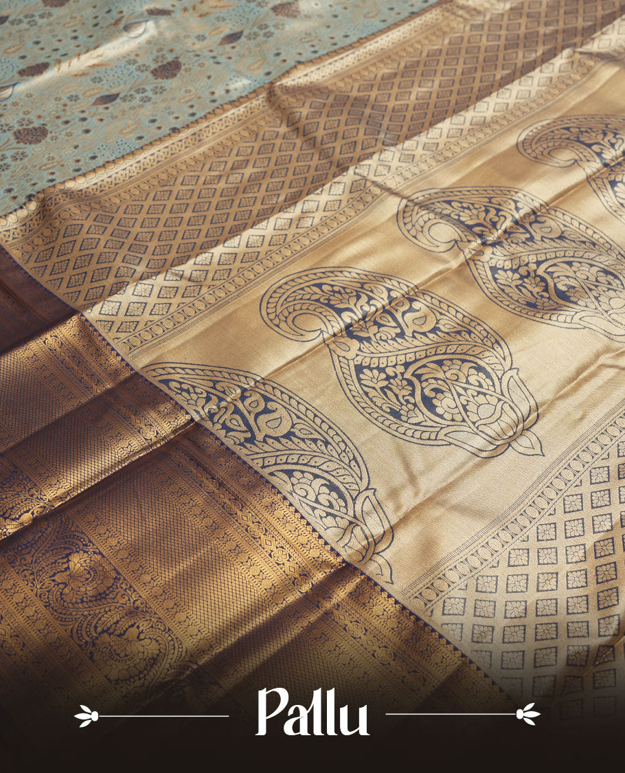 Aqua blue colour and Antique gold Zari Tissue Brocade Saree features intricate floral Motifs on body and navy blue colour border & pallu with traditional patterns paired with matching blouse