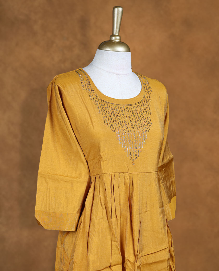 Mustard colour kurti highlighted with intricate cutwork detailing along the scoop neckline, styled with gathered waist and comfy 3/4th sleeves.