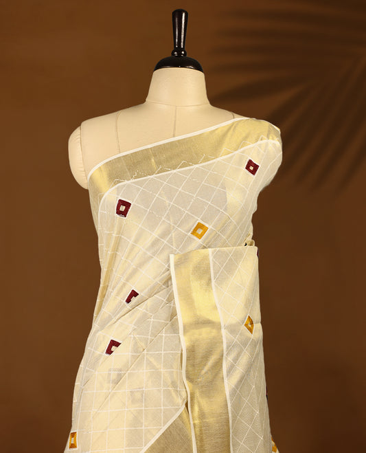 Light Gold colour Tissue Kerala saree featuring thread diamond work on body and a beautifully woven Gold Kasavu border, paired with a matching blouse perfect for festive occasions.
