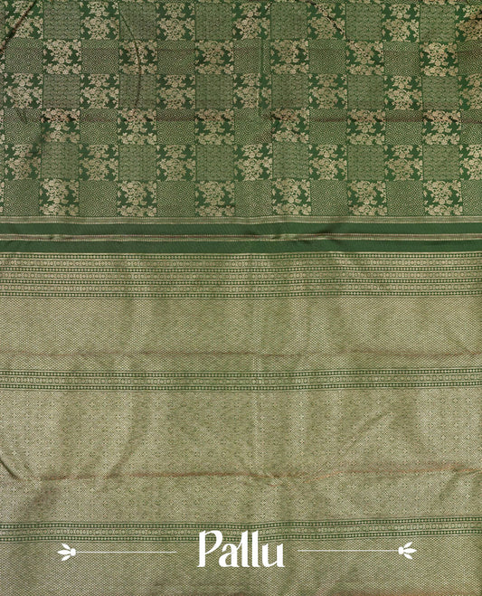Bottle green colour Kanchipuram pattern Manthrakodi saree featuring intricate geometrical design and turning border in antique gold zari jacquard, crafted in rich Kanchipuram silk, paired with a matching jacquard blouse piece.