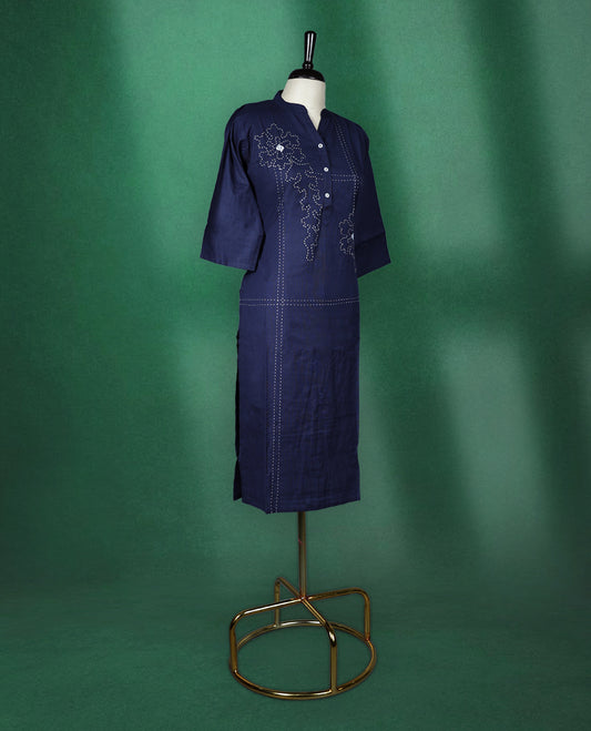 Navy blue colour kurti crafted from soft cotton, featuring a band collar with a buttoned placket, three quarter sleeves, and delicate thread embroidery with floral and dotted patterns for an elegant everyday look.