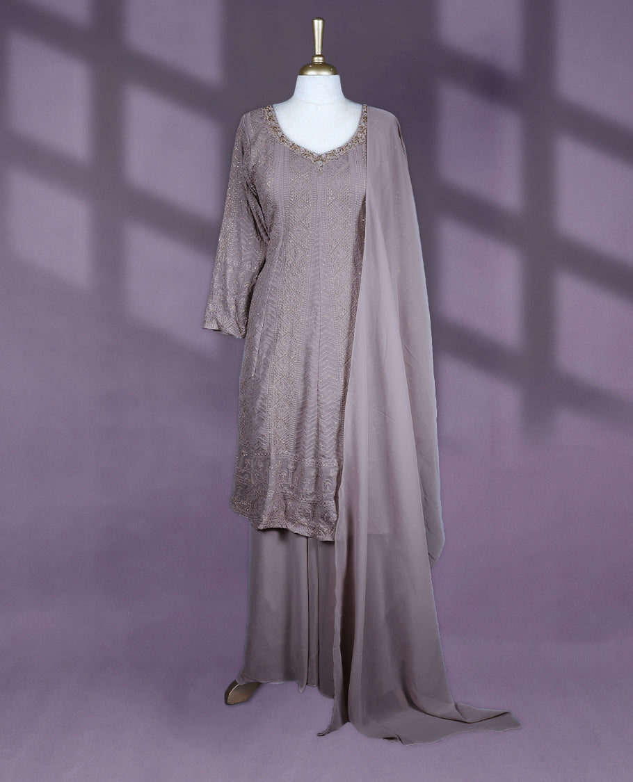 Taupe colour salwar set featuring a V neckline with subtle embellishments, three-quarter sleeves, intricate all-over embroidery, a matching chiffon dupatta, and a coordinated bottom
