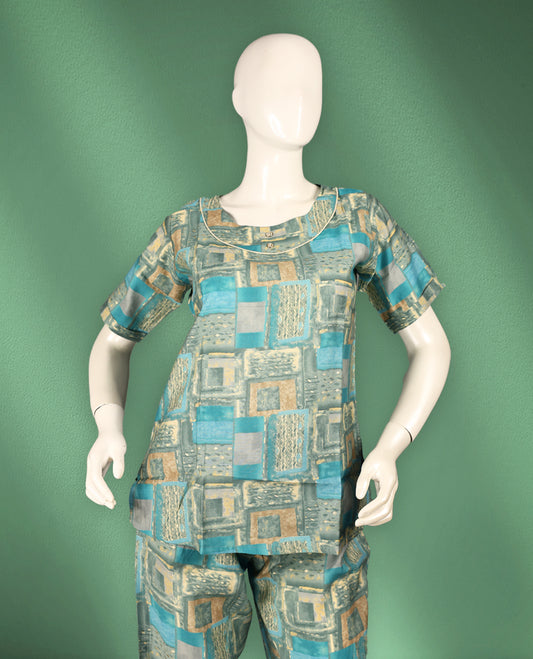 Teal and beige colour geometric print women's nightwear set featuring a round neck with piping detail, short sleeves, and comfortable straight-fit pants.