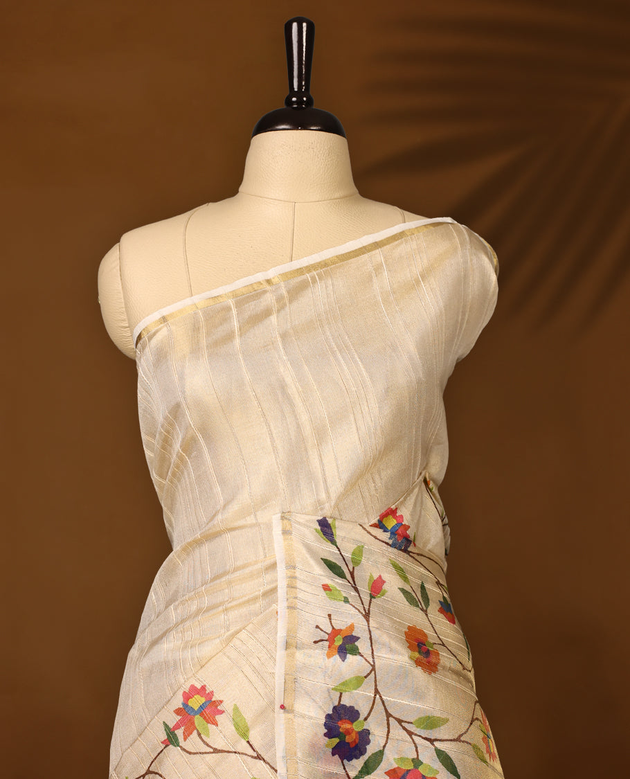 Graceful off white colour organza Kerala saree with vibrant multicolor floral embroidery and a soft golden sheen, Lightweight and elegant, ideal for festive occasions & Comes with a matching blouse piece.