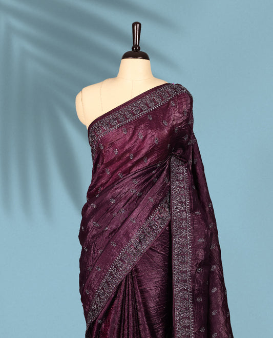 Deep Grape Colour crush soft silk saree, textured body with a natural crinkled finish, adorned with intricate Silver colored floral Motifs and complemented by a delicate Silver Zari embroidery border, paired with a matching blouse