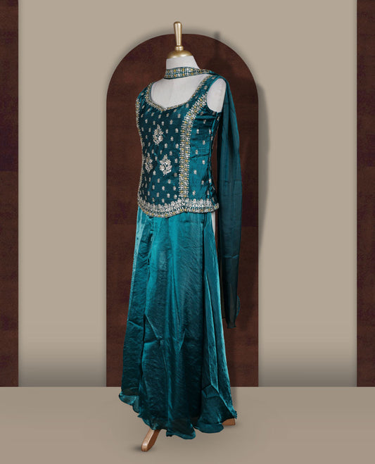 Rich peacock green colour sharara set adorned with intricate light golden embroidery and sequins work & The fitted embellished top pairs beautifully with the flared bottoms and matching dupatta.