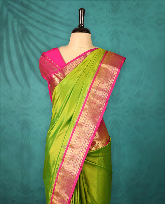Neon Green colour Traditional Kancheepuram Silk saree with small gold motifs on body, Magenta traditional border with intricate gold zari weaving, grand zari pallu, perfect for Bharatanatyam, with matching blouse.