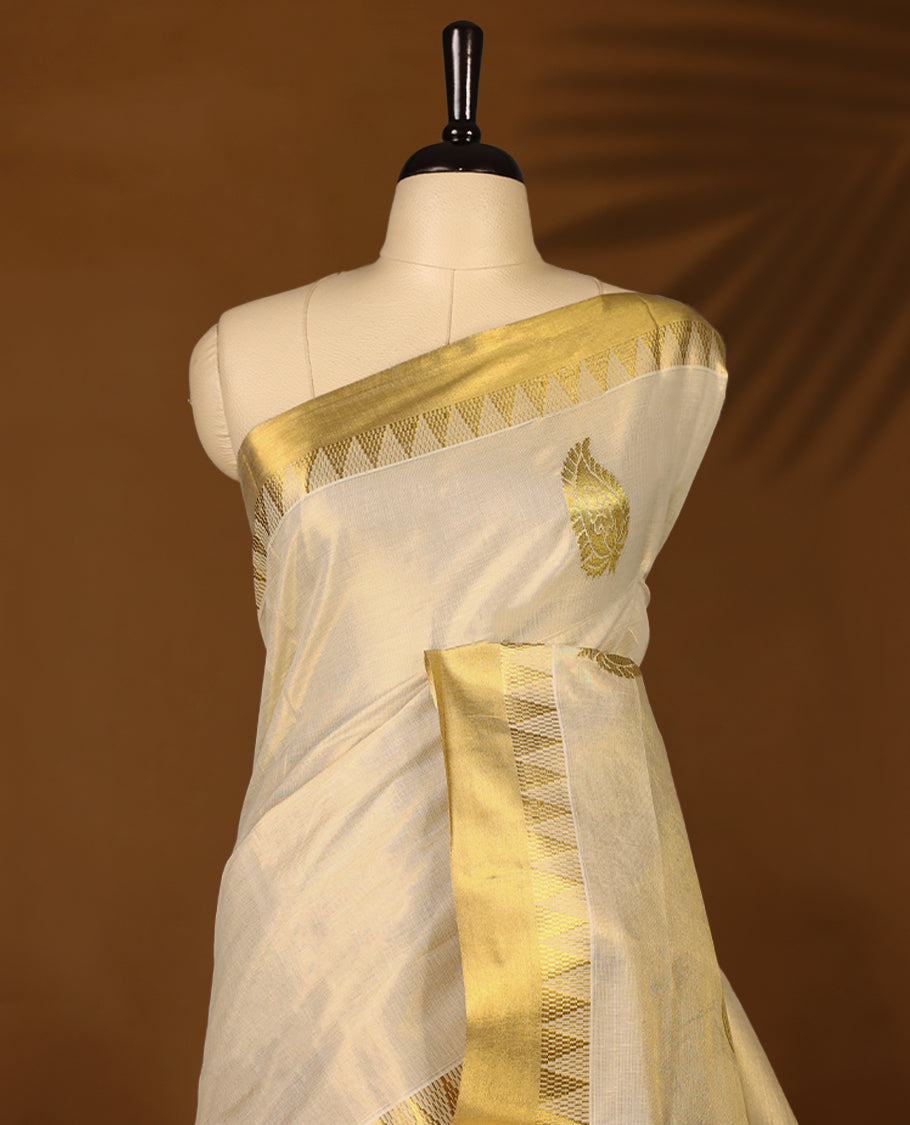 Elegant Light Gold colour Tissue Kerala saree featuring Gold Zari Motifs on body, traditional golden zari kasavu border & Rich Pallu offering a classic and graceful look, paired with a matching blouse.