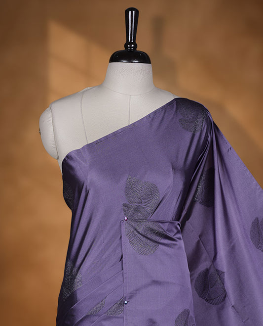 Pastel purple colour semi soft silk saree adorned with delicate woven floral kodi motifs on the body, complemented by a Self colour woven pallu with intricate detailing and tassel accents without border & Comes with a matching blouse piece.