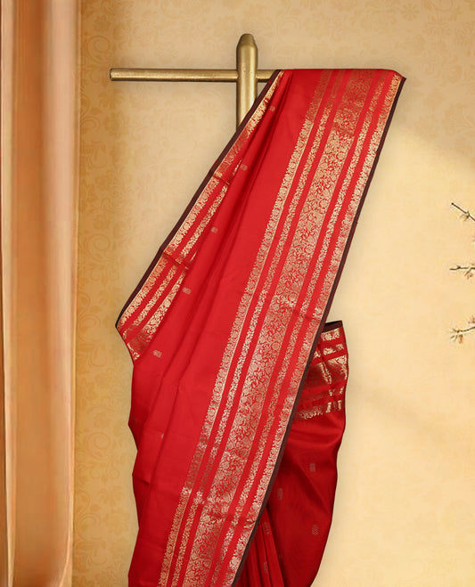 Deep red colour pure Kancheepuram saree with gold zari small floral motifs on the body, traditional border with floral kodi motifs and dark piping grand gold zari woven pallu, paired with contrast matching blouse