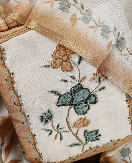 Beige & golden sand colour churidhar material with floral print enhanced by sewn glass beads on the body, paired with plain lavender bottom & floral print dupatta.