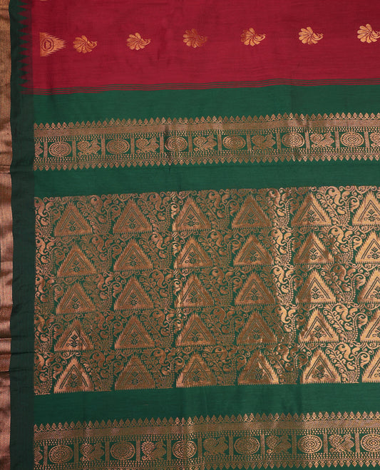 Brick red and Dark Green Kalyani cotton saree featuring delicate golden floral and peacock motifs, highlighted with an intricately woven zari border and pallu, paired with a matching blouse
