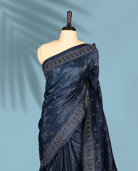 Midnight Blue Colour crush soft silk saree, textured body with a natural crinkled finish, adorned with Silver colored floral Motifs and complemented by a delicate Silver Zari embroidery border, paired with a matching blouse