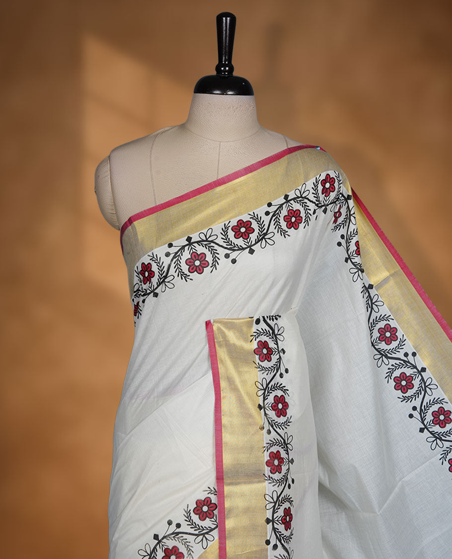 Off white cotton Kerala saree with floral printed borders, highlighted by a golden zari border and classic pallu, paired with a matching blouse.