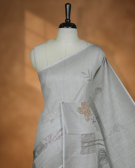 Light Grey colour Linen saree featuring Grey colour fade border with floral beats pattern around floral print across body without border, pallu and matching blouse piece.