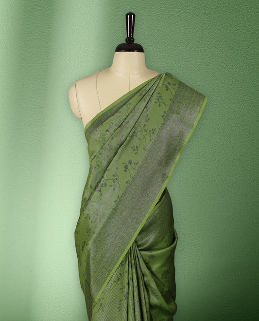 Light green colour semi silk saree featuring neem zari floral kodi motifs all over the body, complemented by a rich self colour woven border, with matching blouse.