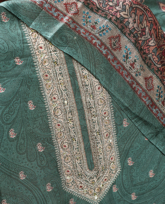 Pine green colour churidhar material featuring intricate paisley prints and delicate embroidery, paired with a plain matching bottom and a printed dupatta.