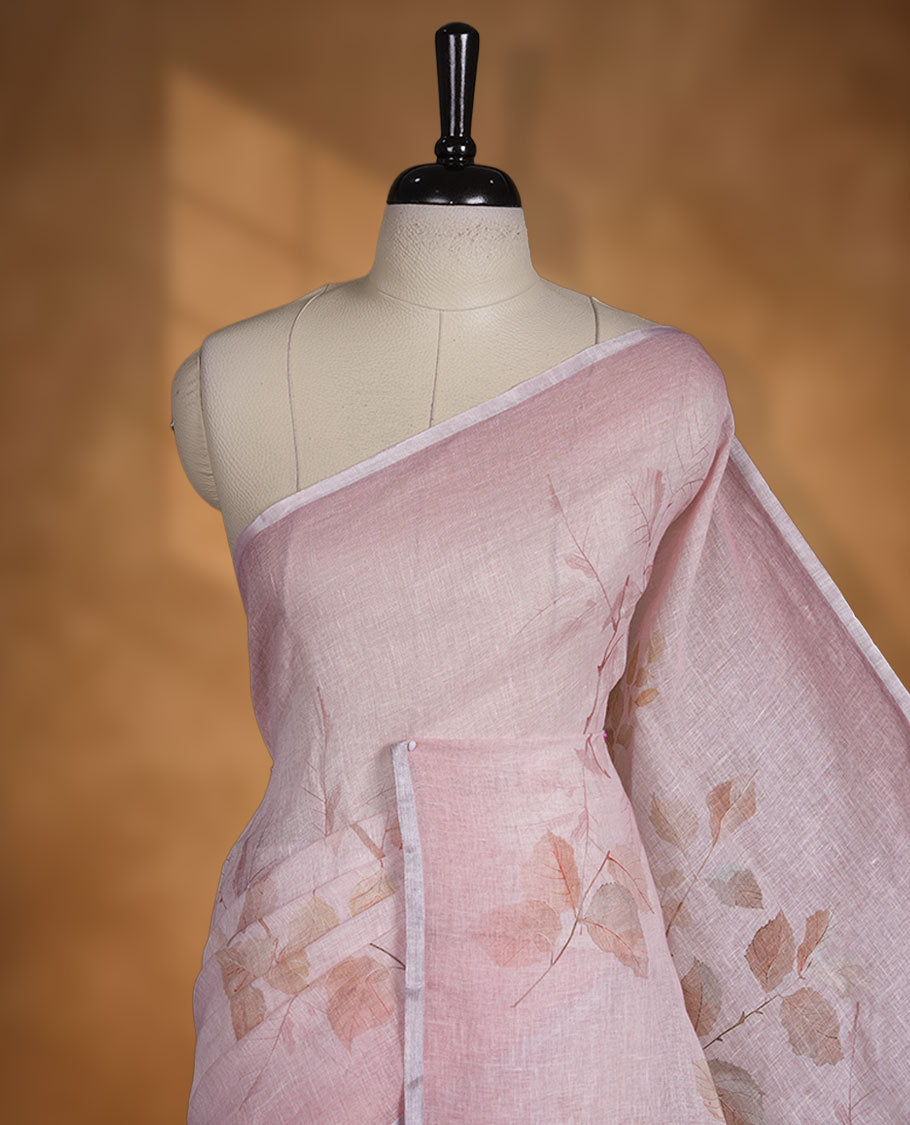 Light pink colour pure linen saree featuring leaf print pattern across body, silver thin border finished with matching blouse.