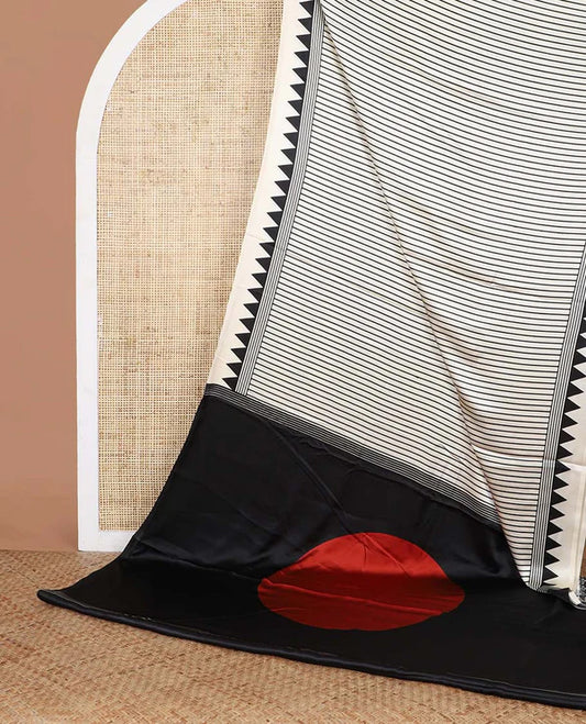 White semi modal crepe saree adorned with black vertical line prints, highlighted by a temple border and circle butta design on the pallu, paired with a coordinated printed blouse.