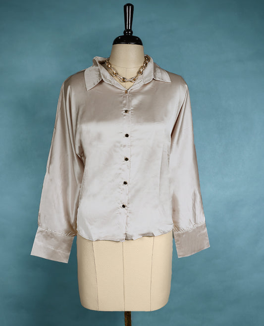 Champagne satin shirt featuring a collared neckline and button down front, designed with long sleeves and a relaxed fit