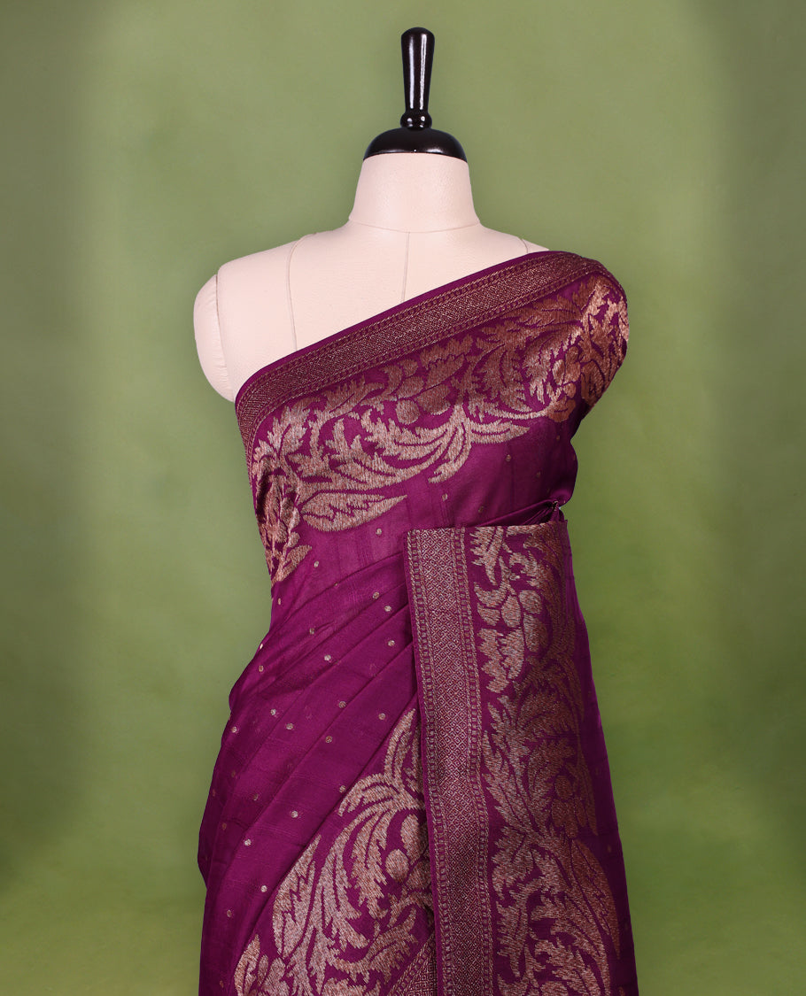Grape wine colour Tussar Banaras saree adorned with delicate golden zari motifs on the body, rich floral woven zari border and grand pallu, paired with a matching blouse for an elegant and regal traditional look.