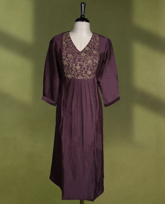 Deep Pastel Purple colour kurti with a V neckline and three quarter sleeves, featuring intricate golden embroidery on the bodice and soft pleats