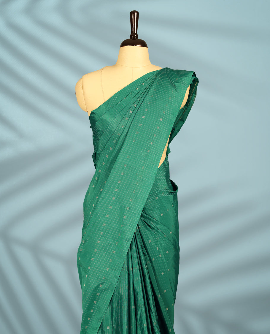 Green Colour semi silk saree showcases delicate square and line motifs all over the body, features a sleek no-border style, and comes with a matching blouse.