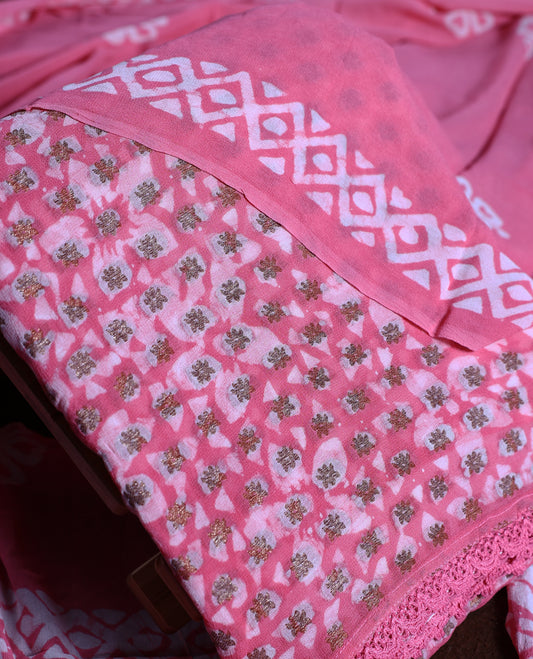 Pink colour churidhar material adorned with gold and copper toned floral patterns and bold block designs, paired with a plain matching bottom & Comes with a floral flowery printed dupatta.