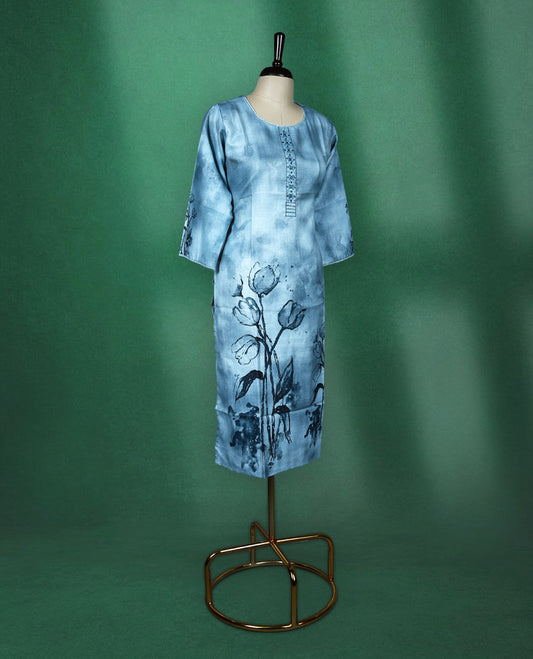 Light blue cotton kurti featuring a serene watercolour floral design near the hem and sleeves, complemented by a round neckline with vertical embroidery detail and three quarter sleeves, graceful pick for a relaxed yet refined look.