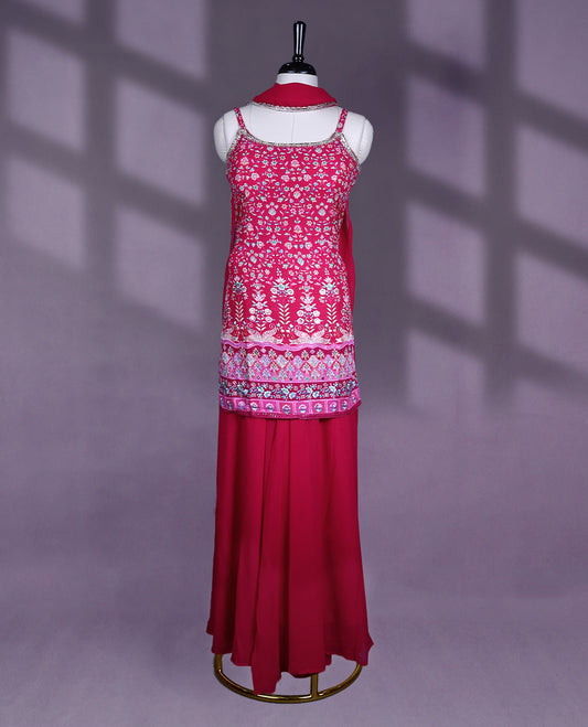 Vibrant raspberry pink colour sharara set features a sleeveless spaghetti strap top with intricate multicolor floral and geometric embroidery, paired with a solid flared bottom and a light, graceful dupatta