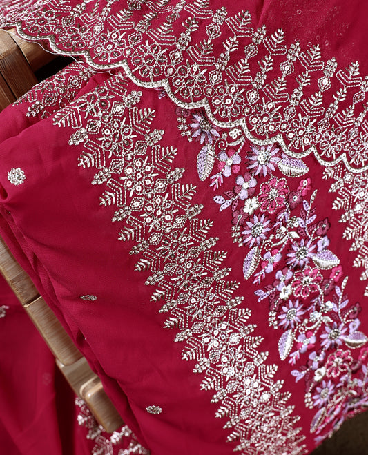 Pinkish red colour churidhar material beautifully designed with golden floral embroidery and multicolour thread highlights, paired with a plain matching bottom and an elegant embroidered dupatta.