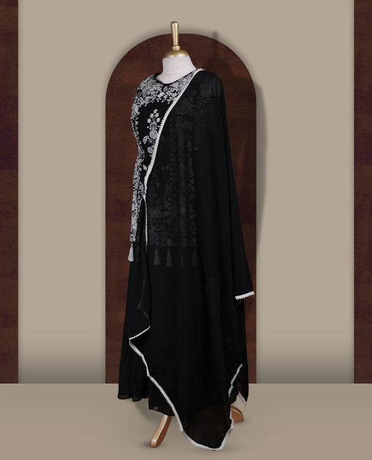 Elegant Black sharara set featuring intricate white floral embroidery,cut beads and small stone work & The outfit includes a beautifully flared bottom for graceful movement and a matching dupatta adorned with tassels for a complete festive look.