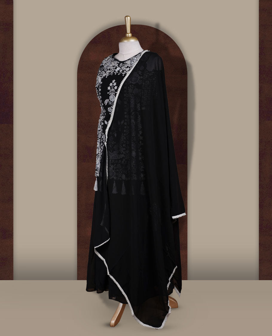 Elegant Black sharara set featuring intricate white floral embroidery,cut beads and small stone work & The outfit includes a beautifully flared bottom for graceful movement and a matching dupatta adorned with tassels for a complete festive look.