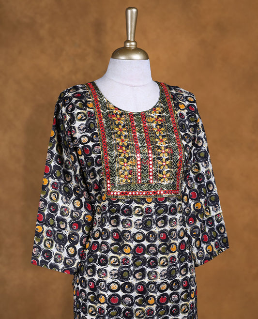 Black colour kurti decked with multicolour circular prints all over, featuring a heavily embroidered yoke with mirror accents, a scoop neckline and comfy 3/4th sleeves.