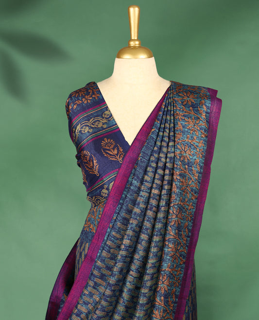 Blue Colour Manipuri saree features a brick patterned body in olive and indigo hues, beautifully offset by a contrasting magenta border with copper floral-printed, and comes with a matching blouse.