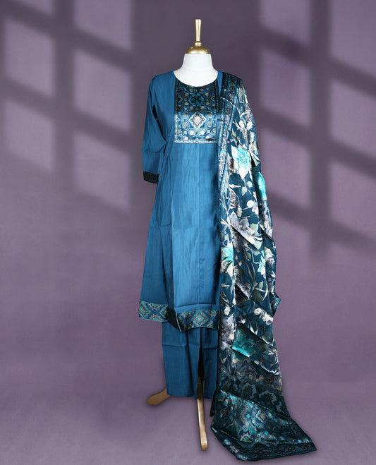 Deep Teal blue colour salwar set with round neck and elbow sleeves featuring printed yoke with ethnic motifs and contrast sleeve hem paired with matching plain bottom and digitally printed floral dupatta