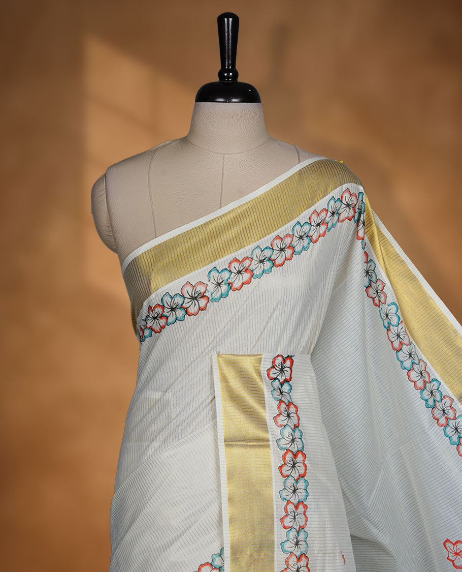Off-white colour Kerala saree featuring floral border detailing with gold kasavu accents, complemented by a matching blouse piece.