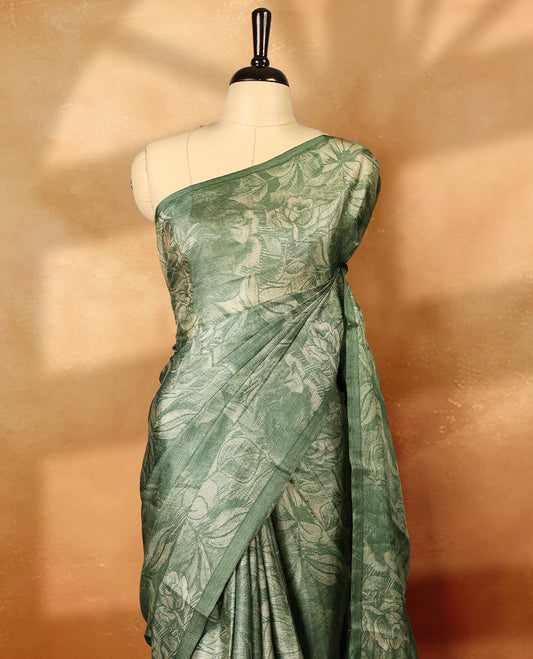 Pastel pista green colour pure tussar silk light weight saree with full body abstract floral print, no defined border and pallu, paired with matching abstract printed blouse.